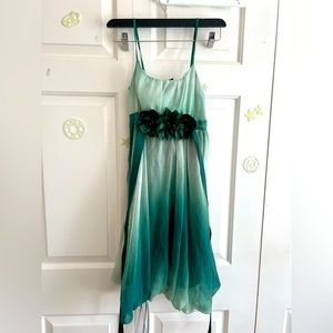 Green summer party dress with floral design.